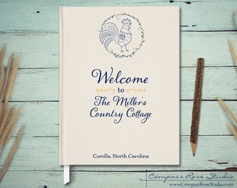 May include: A white book with a blue rooster illustration and the text "Welcome to The Miller's Country Cottage Corolla, North Carolina" and the text "Compass Rose Studio www.CompassRoseStudio.com" at the bottom.