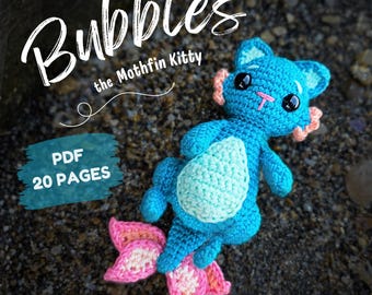 May include: A blue crocheted creature with a light mint belly, pink accents on the ears and tail, and black eyes. The text reads Bubbles the Mothfin Kitty, PDF 20 PAGES, English (US), and CODENAME_BUTTERFLY.