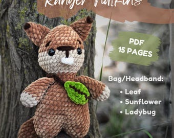 May include: A brown and beige crocheted squirrel plush toy named Ranger Nutkins. The squirrel has black eyes, a white nose, and a green leaf accessory. Text includes PDF 15 PAGES, Bag/Headband: Leaf, Sunflower, Ladybug, and English (US).