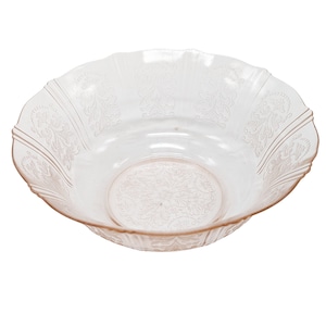 May include: A clear glass bowl with a delicate floral pattern. The bowl is slightly pink in color and has a scalloped edge.