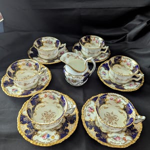 Coalport &quot;Batwing&quot; Cobalt Demitasse Set. 6 cups, 6 saucers, and Creamer. 13 Piece Antique Coalport &quot;Batwing&quot; Demitasse. Brown Center.