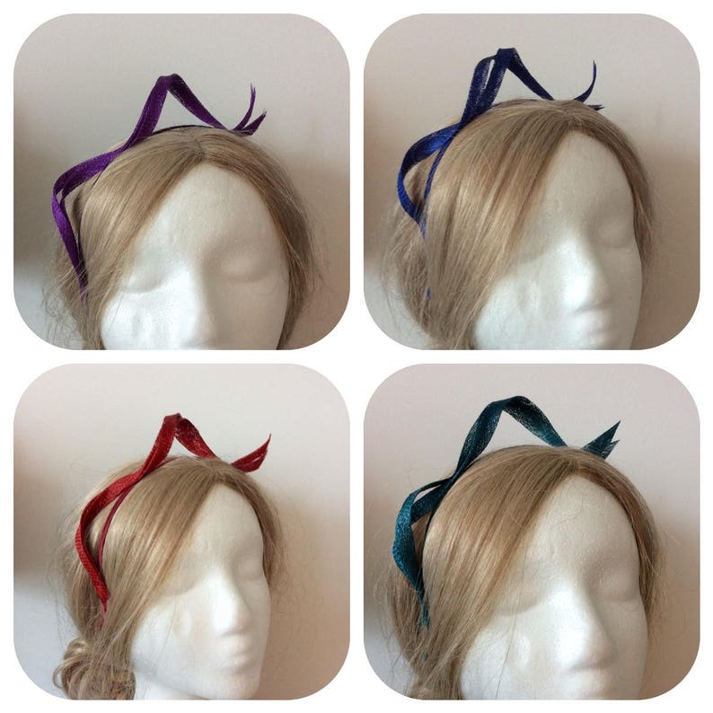 May include: Four headbands in different colors: purple, blue, red, and teal. Each headband is made of a thin, flexible material and has a simple, elegant design.