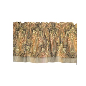 May include: A window valance featuring a multi-colored paisley pattern in shades of rust, olive green, and dark blue. The fabric is gathered at the top for a ruffled effect and finished with a solid, vertically striped border along the bottom edge.