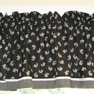 May include: Black and white valance with a white and black striped bottom border. The valance features a repeating pattern of white birds on a black background.