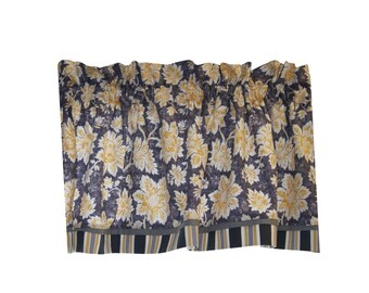 May include: A window valance featuring a dark charcoal gray background with a repeating pattern of light yellow floral blossoms and leaves. The bottom edge is finished with a horizontal band of vertical stripes in charcoal gray, white, and yellow.