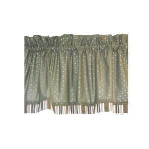 May include: A sage green window valance featuring a repeating pattern of small white squares. The top edge is gathered for a ruffled effect, while the bottom hem is finished with a contrasting border of vertical stripes in brown, white, and gray.