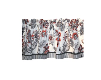 May include: A window valance featuring a white background with a floral pattern in shades of red, grey, and black. The fabric has a gathered top for hanging and a bottom border with a black and white vertical stripe design along the hemline.