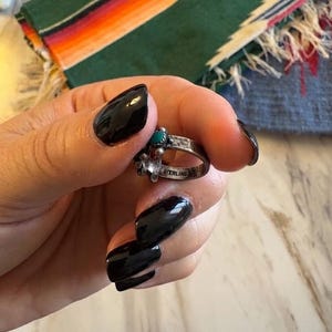 This ZUNI SNAKE EYES RiNG is kinda fabulous.  It came out of a Tucson trading post and is a Fred Harvey era Treasure!  It's sterling and has 5 turquoise snake eyes.  Tiny round raindrops adorn  the sides of the ring.  Size 4-1/2.  Original patina left.

ZUNI SNAKE EYES is a masterful lapidary style originally developed by Zuni Pueblo artists around the 1930s and 1940s. It's one of the most incredibly labor-intensive and meticulous techniques in Native American jewelry making.