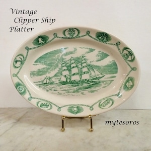 May include: Vintage oval platter with a green clipper ship design. The platter has a white background with a green border featuring nautical symbols. The text "Vintage Clipper Ship Platter" is visible.