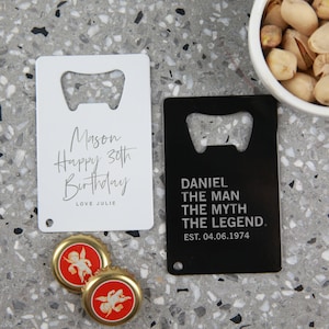 May include: Two metal bottle openers. One is white with the text "Mason Happy 30th Birthday LOVE JULIE". The other is black with the text "DANIEL THE MAN THE MYTH THE LEGEND. EST. 04.06.1974".