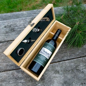 May include: A wooden gift box containing a bottle of red wine and a wine opener set. The box is open and the wine bottle is visible. The label on the wine bottle reads "WYNNS Coonawarra Estate Cabernet Sauvignon 2019."