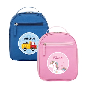 May include: Two personalised lunch bags. One is blue with a red and yellow truck graphic and the name "WILLIAM". The other is pink with a unicorn graphic and the name "Charli". Both have a zip and a handle.