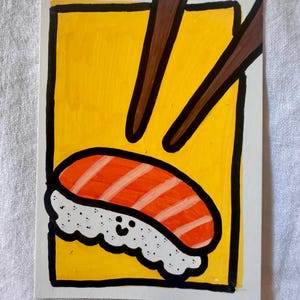 May include: A hand-drawn illustration of sushi nigiri with chopsticks. The sushi features orange fish with white stripes atop white rice, set against a yellow background with a black border. Brown chopsticks are positioned above the sushi.