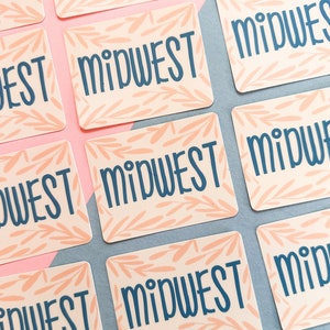 Midwest sticker in cornflower blue on a pink hand-drawn vine background.