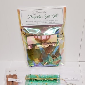 May include: A prosperity spell kit with a white scroll, a green candle, a small bag of herbs, a bottle of oil, and a citrine crystal. The kit is packaged in a clear plastic bag with a label that reads "Botanica Magick Prosperity Spell Kit".