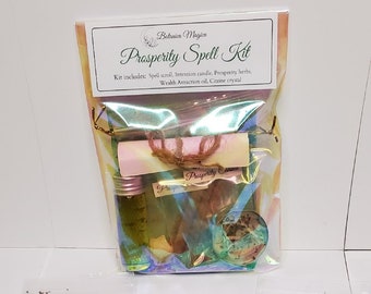 May include: A prosperity spell kit with a white scroll, a green candle, a small bag of herbs, a bottle of oil, and a citrine crystal. The kit is packaged in a clear plastic bag with a label that reads "Botanica Magick Prosperity Spell Kit".