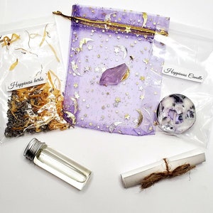 May include: A collection of spiritual items, including a small bottle, a scroll tied with twine, a purple pouch with gold stars and moons, a crystal, a candle, and a bag of herbs. The bags are labeled "Happiness herbs" and "Happiness Candle".
