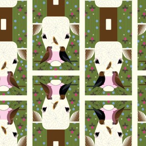 May include: A repeating pattern of white cow heads with brown noses and black eyes. The cow heads are surrounded by green and brown stripes and a pattern of pink and blue dots. There are also small pink and brown birds with black eyes and black and white birds with black eyes.