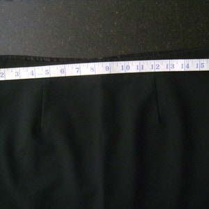 May include: Black skirt with a measuring tape showing the length is 18 inches.