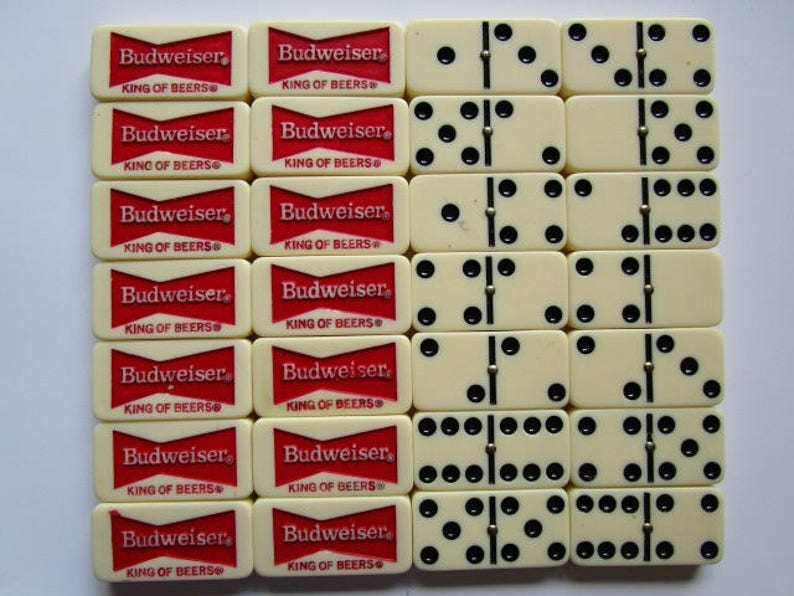 May include: A set of dominoes with black dots on white tiles. The dominoes are arranged in a grid pattern. The tiles are surrounded by red and white tiles with the text "Budweiser King of Beers" printed on them.