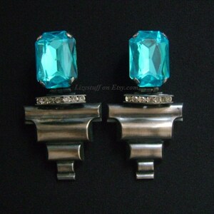 May include: A pair of silver tone clip-on earrings with turquoise blue faceted glass stones and clear rhinestone accents.  Lizystuff on Etsy.com