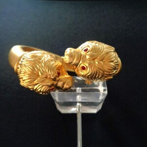 May include: Gold bracelet with two lion heads, each with red gemstone eyes.