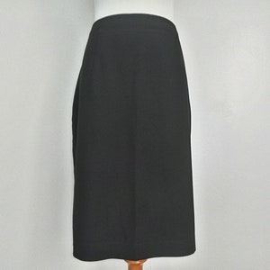 May include: A black pencil skirt with a straight silhouette.