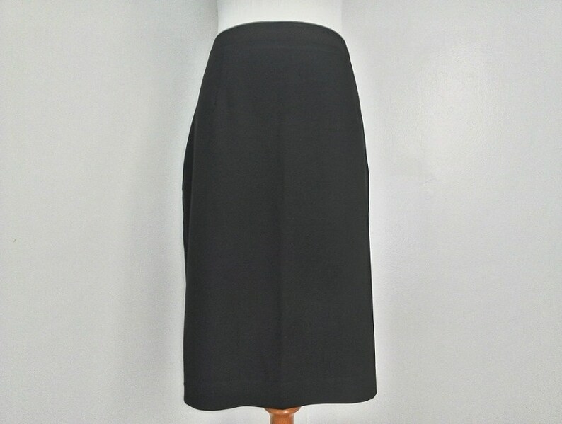 May include: A black pencil skirt with a straight silhouette.