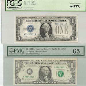 May include: Two graded US dollar bills. The top bill is a 1928A $1 Silver Certificate graded 64PPQ Very Choice New. The bottom bill is a 1977A $1 Federal Reserve Note graded 65 Gem Uncirculated. Both bills feature a portrait of George Washington.