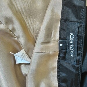 May include: A black skirt with a beige lining and a Karen Kane label. The size tag shows size 8.