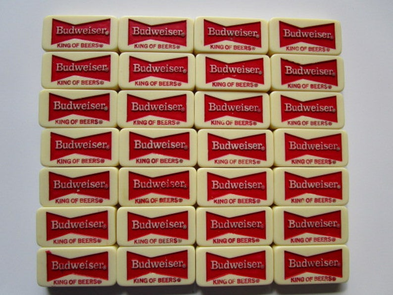 May include: Twenty-eight white dominoes with red lettering. Each domino reads "Budweiser King of Beers".