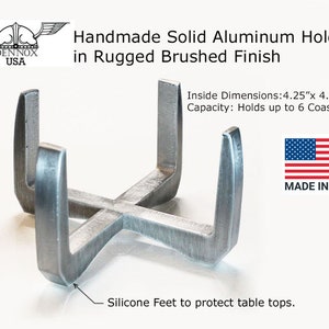 May include: A silver aluminum coaster holder with a rugged brushed finish. It has a capacity of up to 6 coasters and measures 4.25 inches by 4.25 inches by 2 inches high. The holder has silicone feet to protect tabletops. Made in the USA.