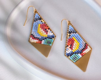 May include: A pair of gold earrings with a geometric diamond shape. The earrings are made of small colorful beads and have a gold metal backing.