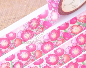 May include: Pink washi tape with a floral pattern of pink flowers and green stems. The tape is rolled up and has a label that says "Akara's Wish".