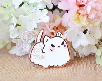 May include: White enamel pin of a cartoon cat with angry eyes and a fluffy white body. The pin is surrounded by white and pink flowers.