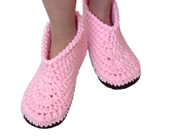 May include: A pair of pink crocheted slippers with brown soles.