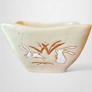 May include: A set of three ceramic mugs with a speckled, matte finish in cream, light grey, and dark grey. Each mug has a simple, minimalist design, ideal for coffee or tea.