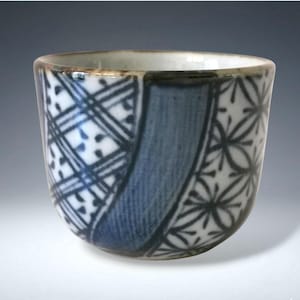 May include: A trio of white ceramic vases in different sizes and forms. Each vase has a matte finish and a textured, ridged pattern. They are displayed on a neutral surface, highlighting their minimalist design. The vases are suitable for home decor.