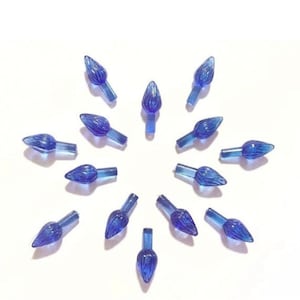 May include: A close-up of 15 blue plastic Christmas light bulb tips. The tips are arranged in a circle on a white background.