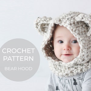 May include: A crochet bear hood pattern with a white and brown color scheme. The pattern is shown on a baby wearing the hood.