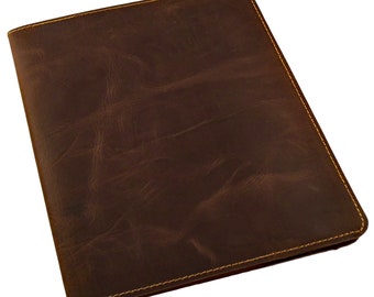 May include: A brown leather notebook cover with a stitched edge.