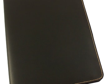 May include: A black leather notebook with gold stitching around the edges.