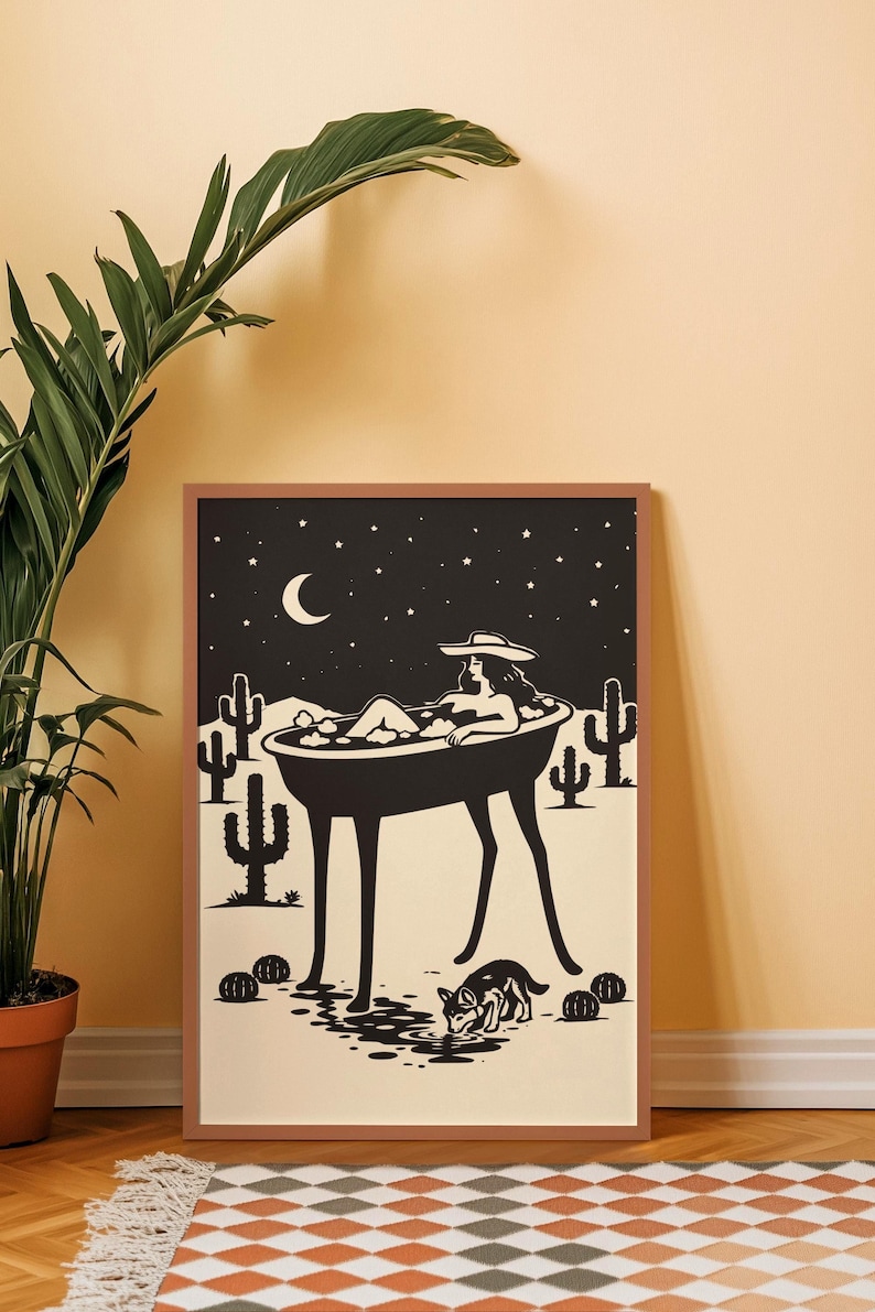 May include: Black and white art print depicting a person relaxing in a bathtub under a starry night sky with a crescent moon. The scene includes cacti, a dog drinking water, and a framed border.