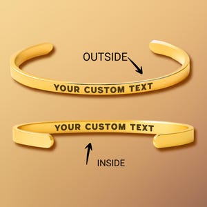 May include: Two gold-colored, open cuff bracelets. The top bracelet shows the word "OUTSIDE" with an arrow pointing to the outside of the bracelet. The bottom bracelet shows the word "INSIDE" with an arrow pointing to the inside of the bracelet. Both bracelets have the text "YOUR CUSTOM TEXT".