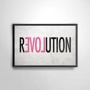 May include: Black framed wall art with the word "revolution" written in pink and black letters on a white background.