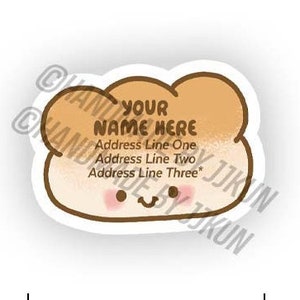 May include: A brown and white cartoon bread sticker with a smiling face. The sticker has the text "YOUR NAME HERE" and space for an address. The sticker is 4 cm wide and 2.9 cm tall.
