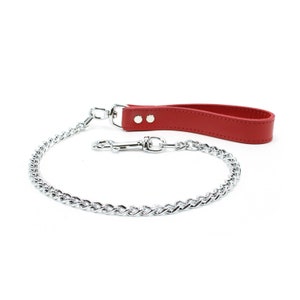 May include: A red leather dog leash with a silver chain and a metal clip.