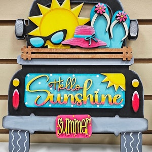 May include: Black wooden truck with a yellow sun, pink hat, blue flip flops, and the text "Hello Sunshine" and "Summer" on the back.