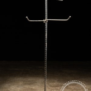 May include: A chrome-plated metal stand with four arms for hanging items. The stand has a round base and a twisted pole.