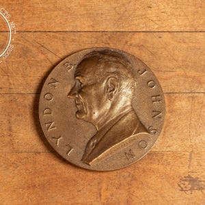 May include: A bronze medal with a profile portrait of Lyndon B. Johnson and the text "LYNDON B. JOHNSON" around the edge.